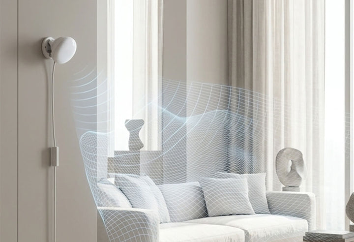 A discreet white millimeter-wave radar sensor monitoring a smart home living room area.